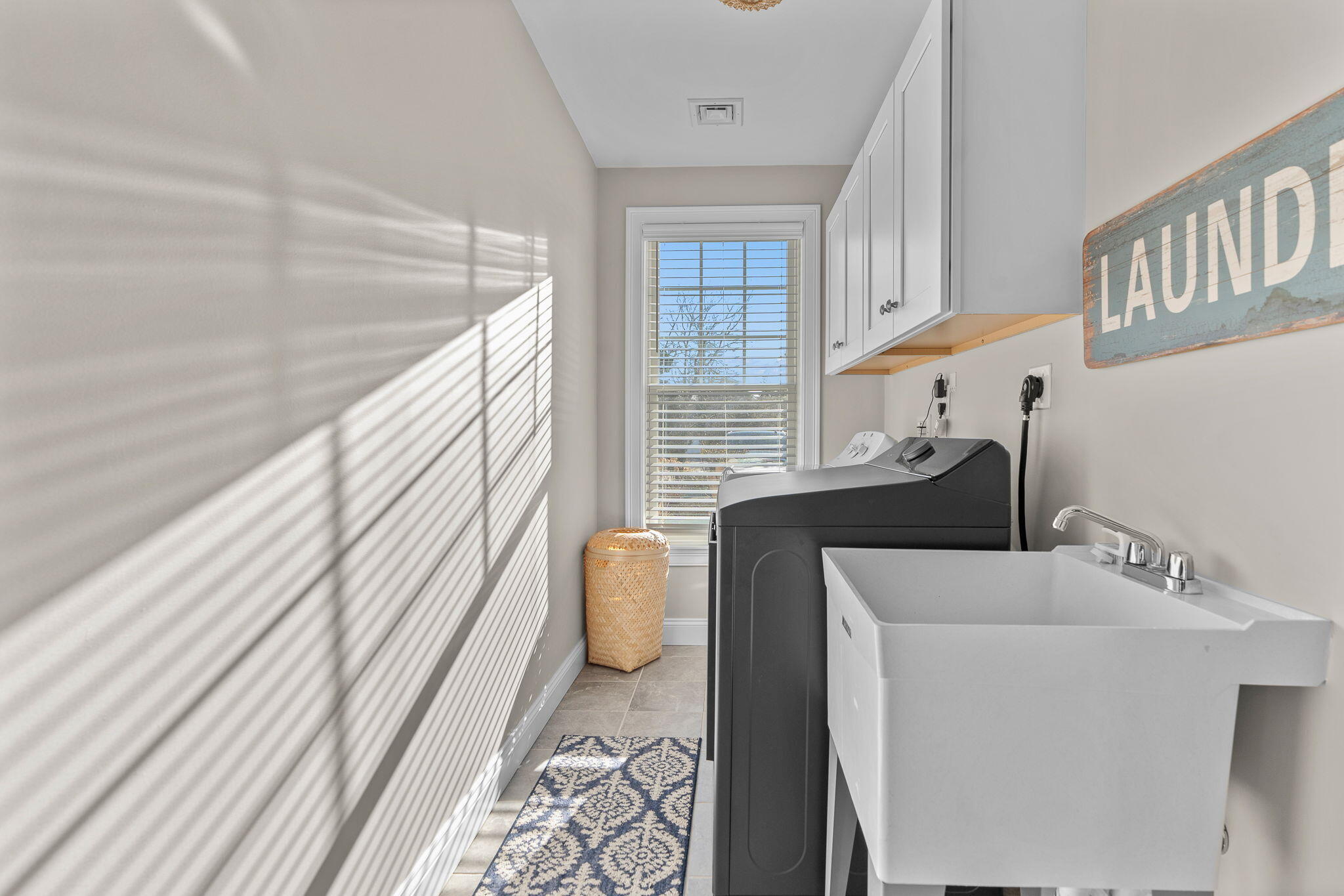 12 South Cedar Street Centerville, MA 02632 - Photo 26 of 42 a living room with furniture and a floor to ceiling window