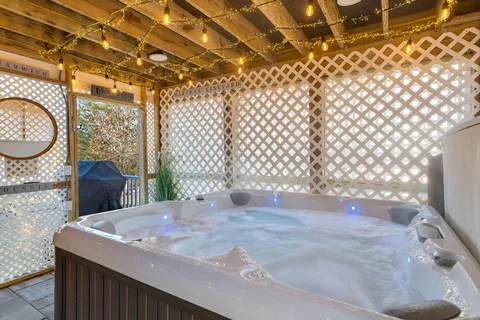 a front view of a house with swimming pool and sitting area