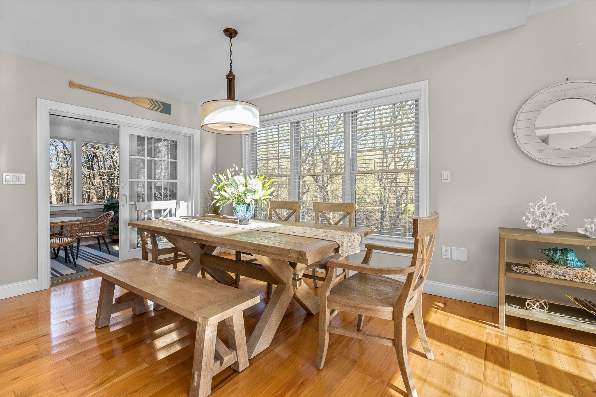 12 South Cedar Street Centerville, MA 02632 - Photo 6 of 42 a dining room with wooden floor a chandelier a wooden table and chairs