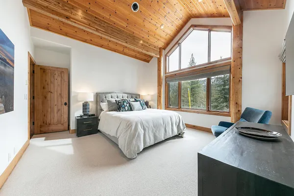 a bedroom with a large bed and a large window