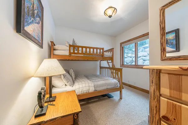 a bedroom with a bed and a lamp on table