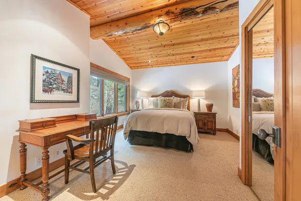 a bedroom with a bed and a painting on the wall