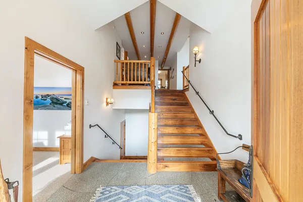 a view of entryway and hall with wooden floor