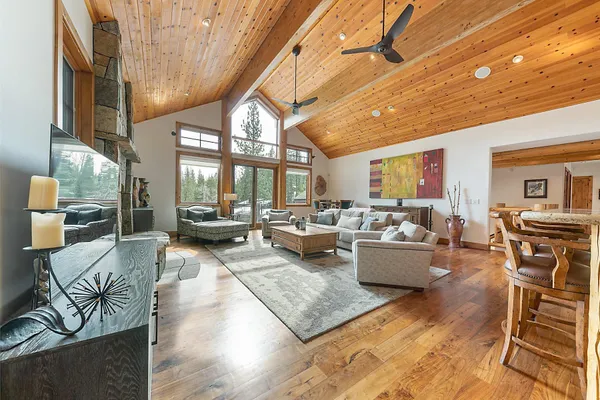 a living room with fireplace furniture and a table