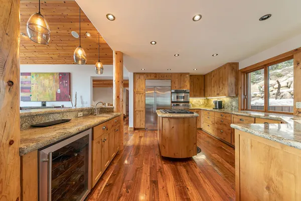 a kitchen with stainless steel appliances granite countertop a stove and a sink