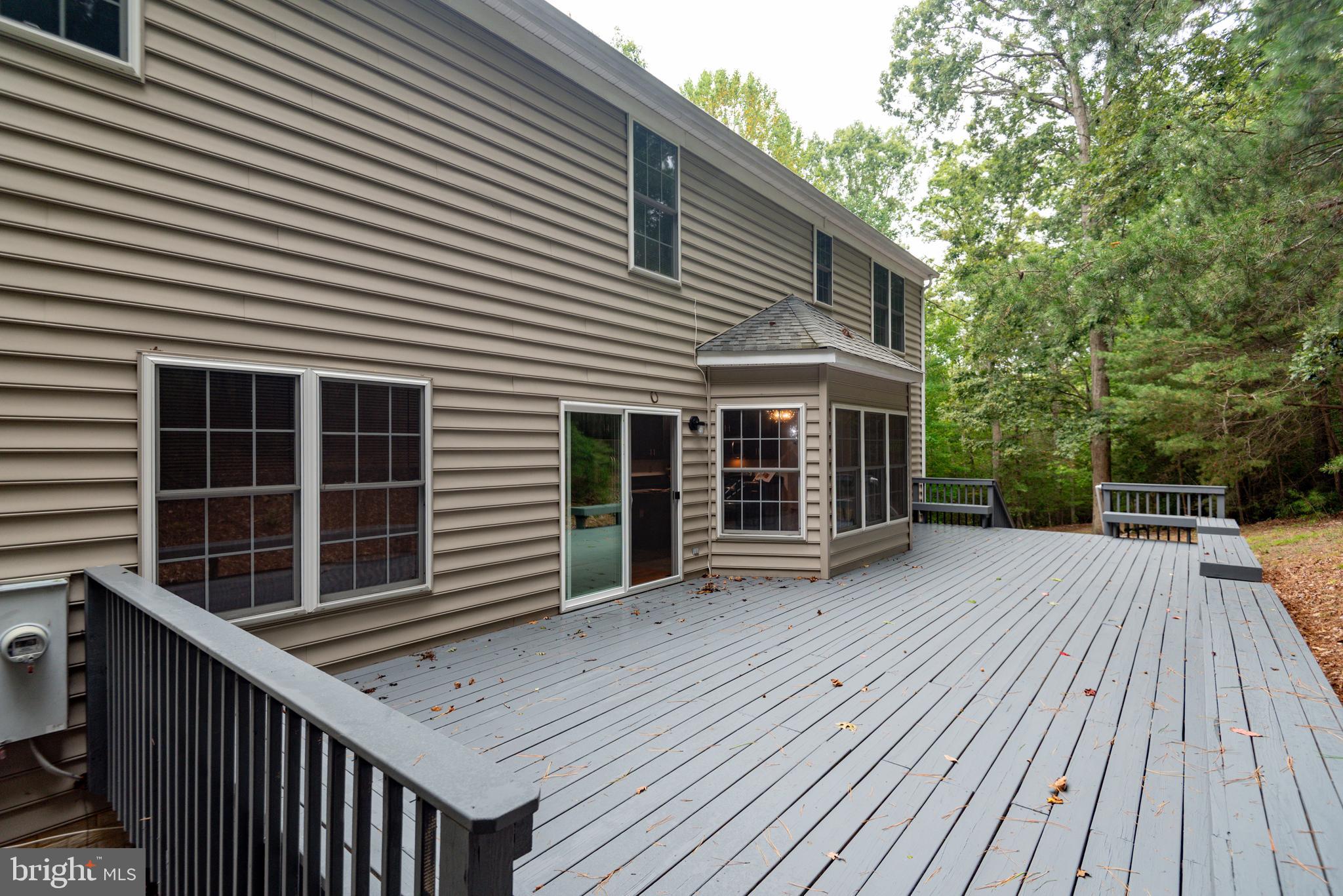 1780 Rudolph Lane Lusby, MD 20657 - Photo 3 of 40 a view of house with deck outdoor seating and covered with trees in the side