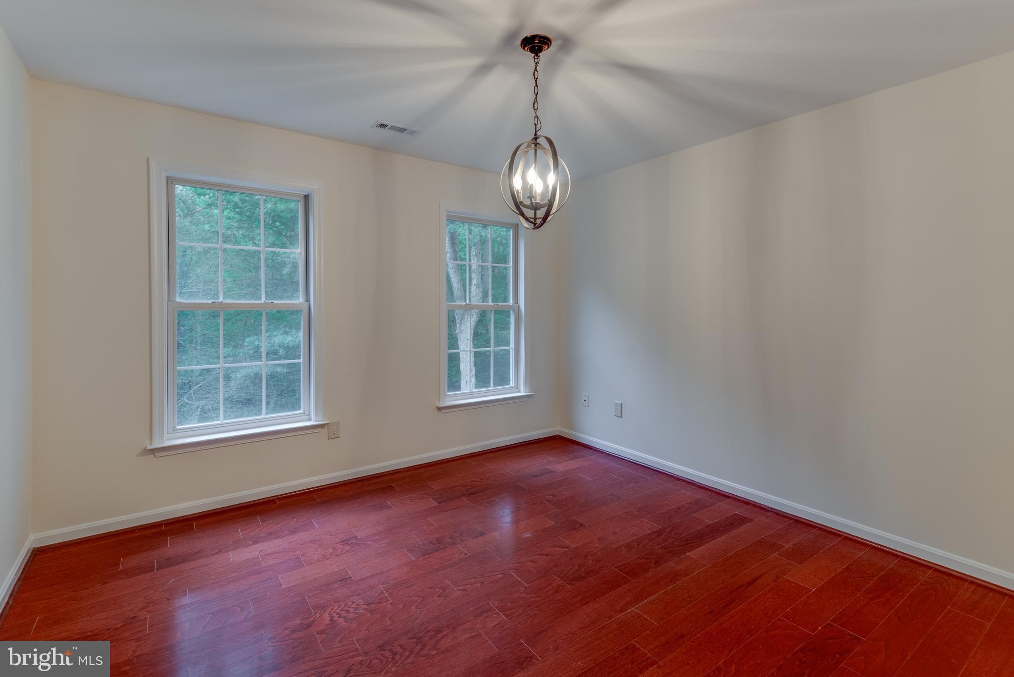 1780 Rudolph Lane Lusby, MD 20657 - Photo 34 of 40 en empty room with windows and ceiling fan