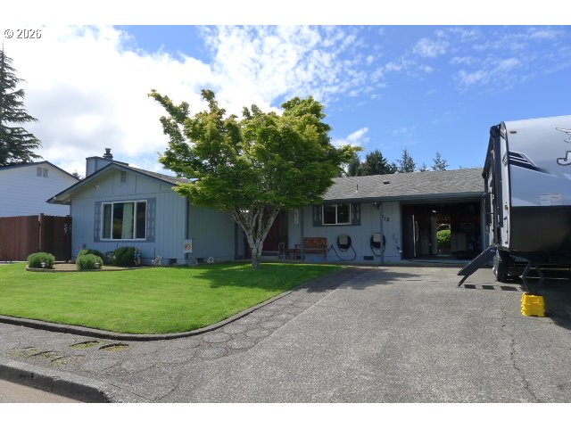 412 Camellia Court Reedsport, OR 97467 - Photo 4 of 48 a view of a house with backyard and a tree