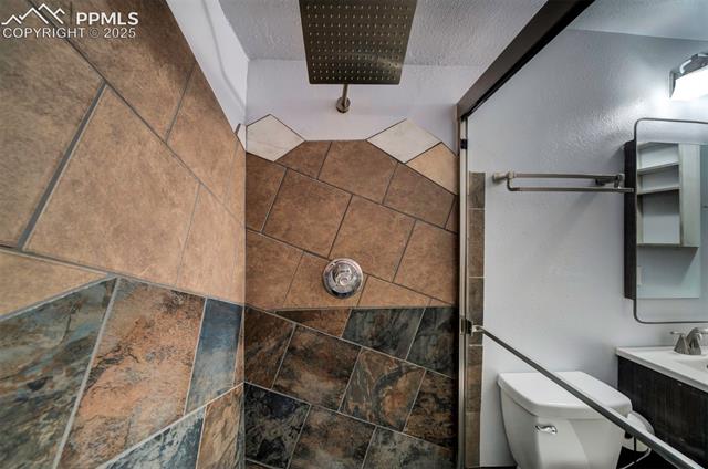 3870 Half Turn Road Colorado Springs, CO 80917 - Photo 33 of 34 Full bath featuring a tile shower and toilet