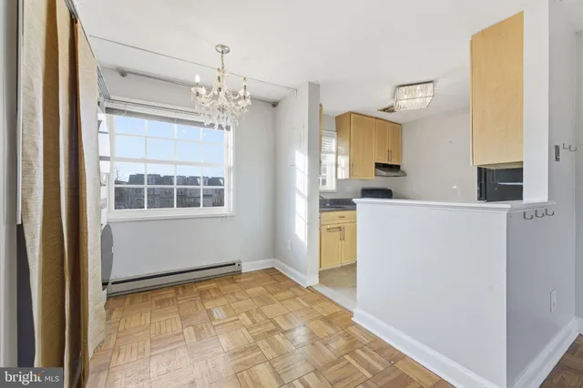 a view of a kitchen with a sink cabinet and an entryway