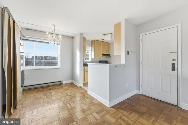 a view of a kitchen with wooden cabinet and a window