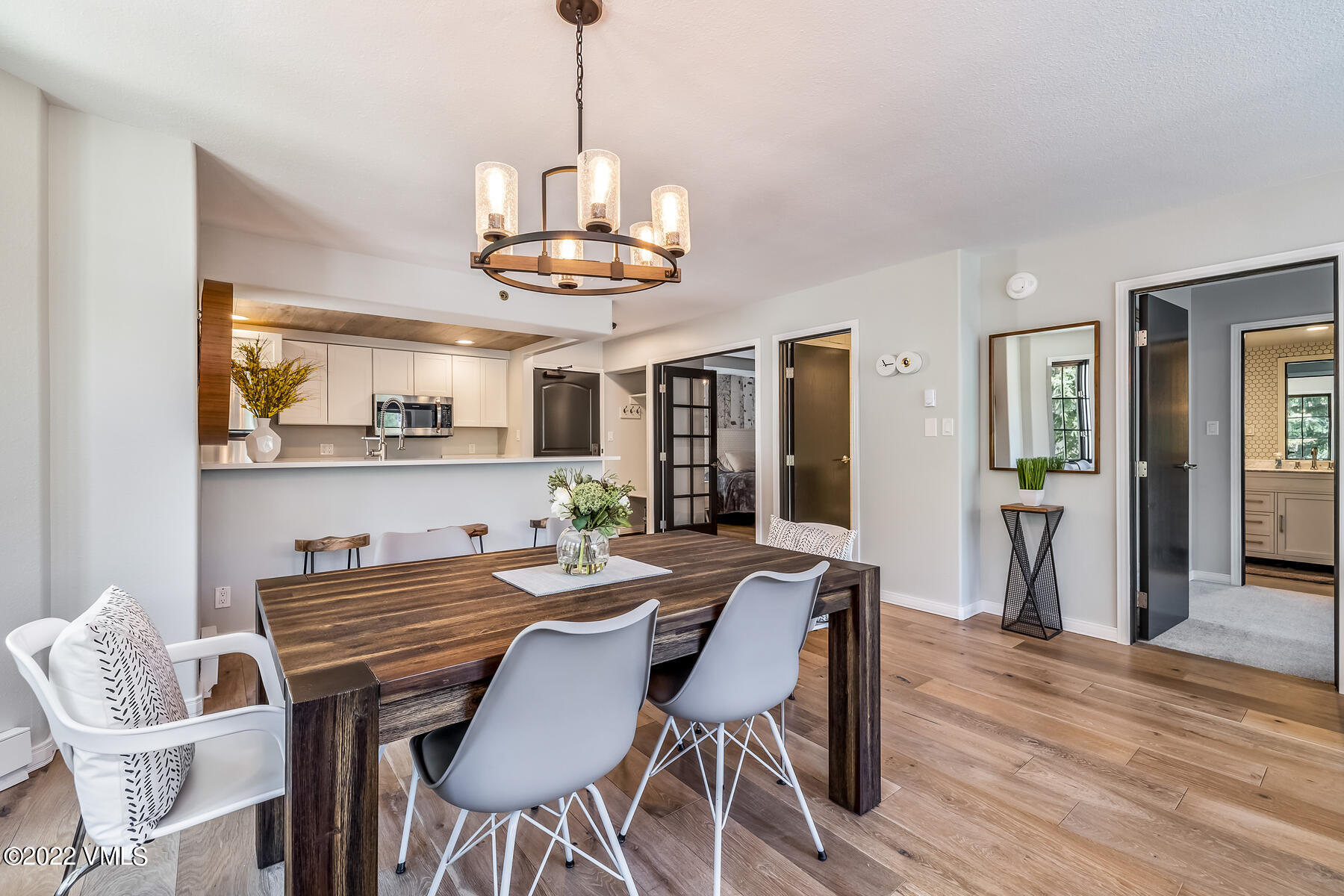 1120 Village Road, Unit 402 Beaver Creek, CO 81620 - Photo 20 of 46 a view of a dining room with furniture wooden floor and chandelier