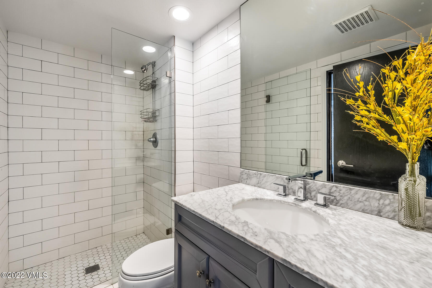 1120 Village Road, Unit 402 Beaver Creek, CO 81620 - Photo 25 of 46 a bathroom with a granite countertop toilet sink and mirror