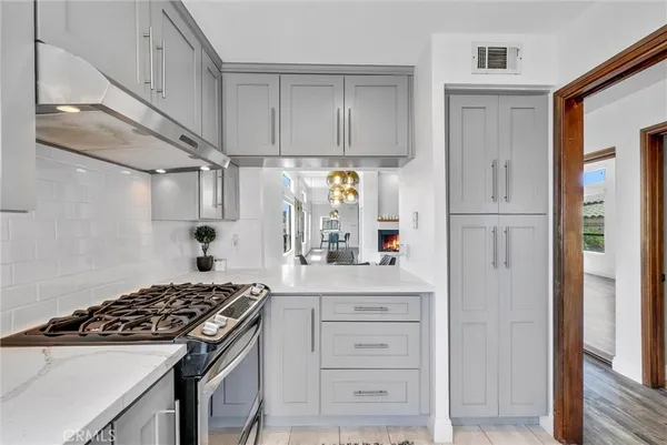 a kitchen with cabinets appliances and a window