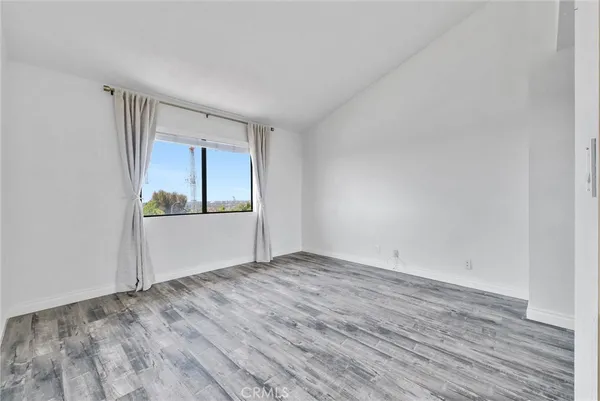 an empty room with wooden floor and closet
