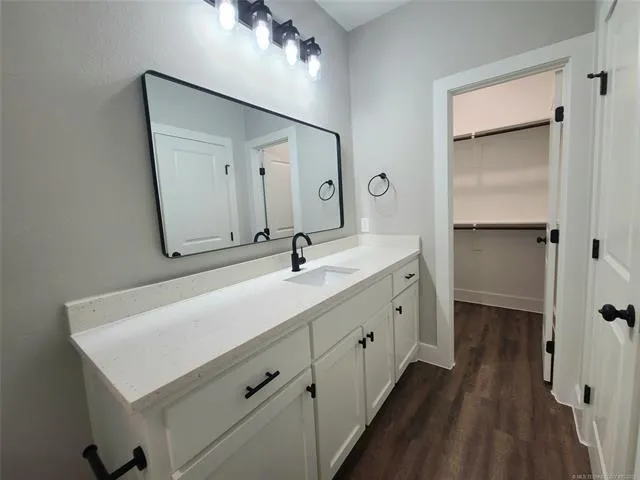 a bathroom with a sink a mirror and a shower