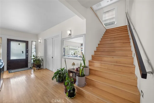 a view of entryway with wooden floor and stairs