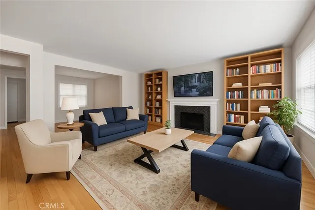 a living room with furniture fireplace and a table