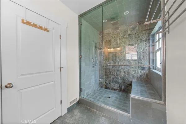 a bathroom with a glass shower door