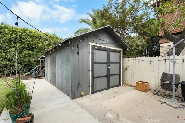 a backyard of a house with wooden fence and trees