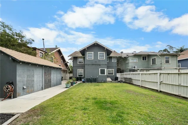a view of a house with a big yard and sitting area