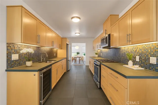 a kitchen with stainless steel appliances granite countertop a sink and stove