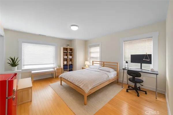 a bedroom with a bed and a desk