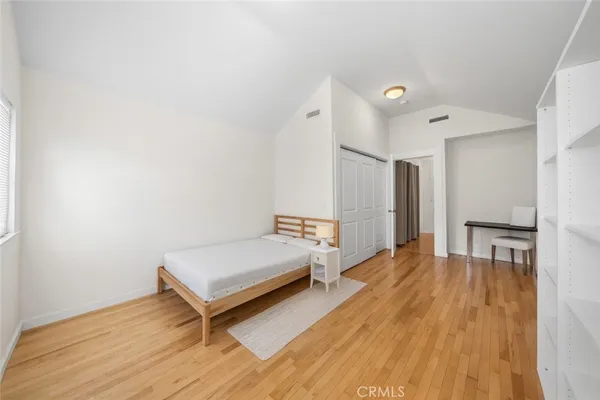 a spacious bedroom with a bed and a table