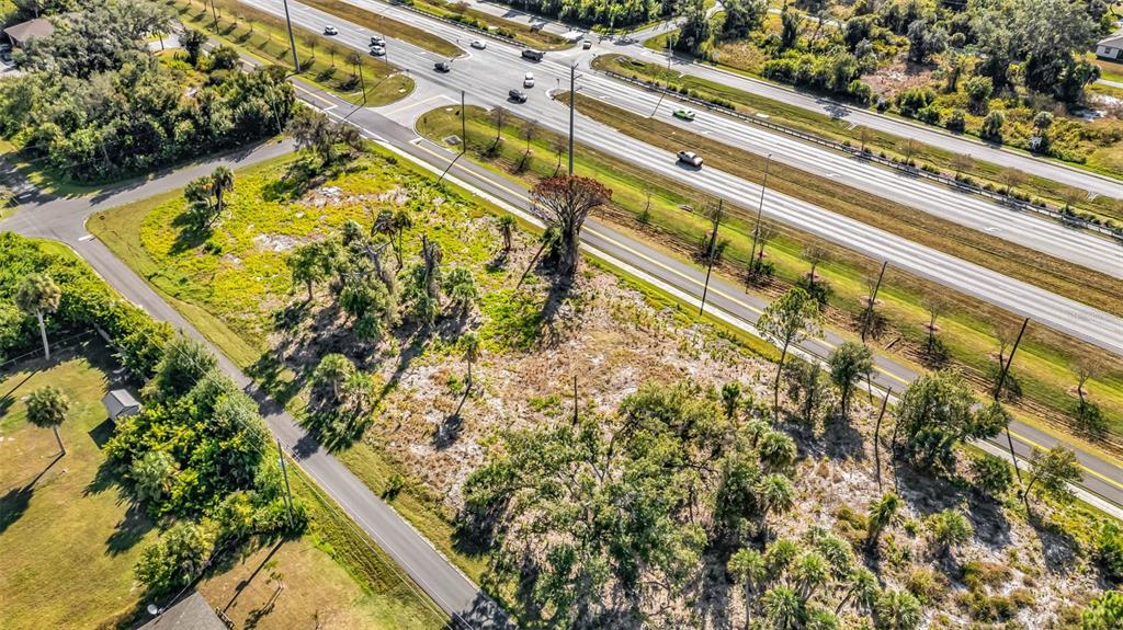 3280 North Access Road Englewood, FL 34224 - Photo 21 of 26 view of swimming pool with a garden and plants