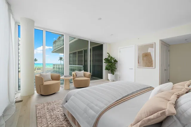 a bedroom with furniture and a large window