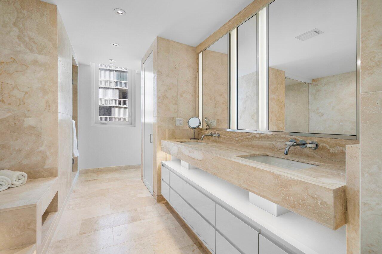 3550 South Ocean Boulevard, Unit 2D South Palm Beach, FL 33480 - Photo 17 of 55 a spacious bathroom with a granite countertop sink a mirror and a bathtub
