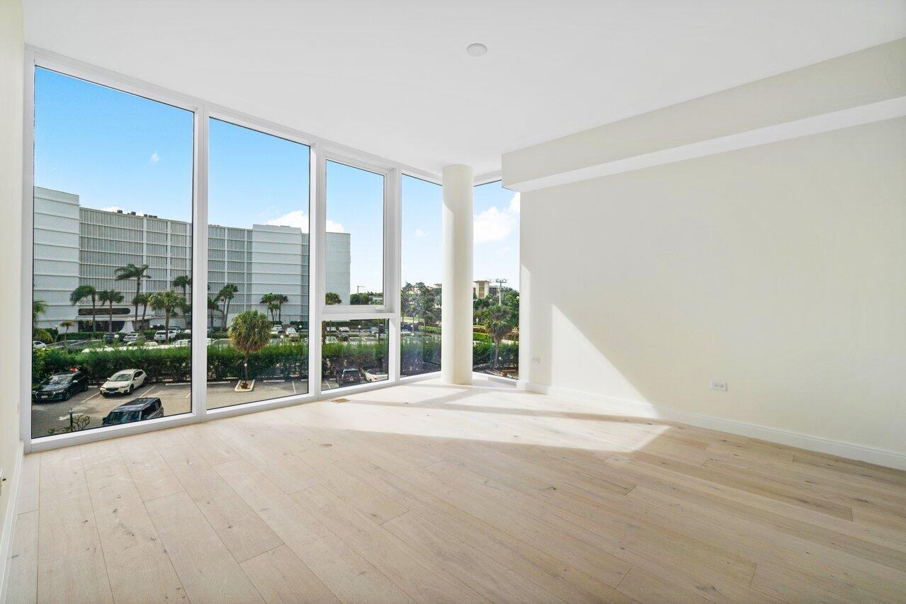 3550 South Ocean Boulevard, Unit 2D South Palm Beach, FL 33480 - Photo 21 of 55 a view of an empty room with wooden floor and a window