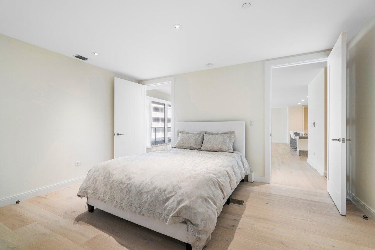3550 South Ocean Boulevard, Unit 2D South Palm Beach, FL 33480 - Photo 23 of 55 a bedroom with a bed and a night stand