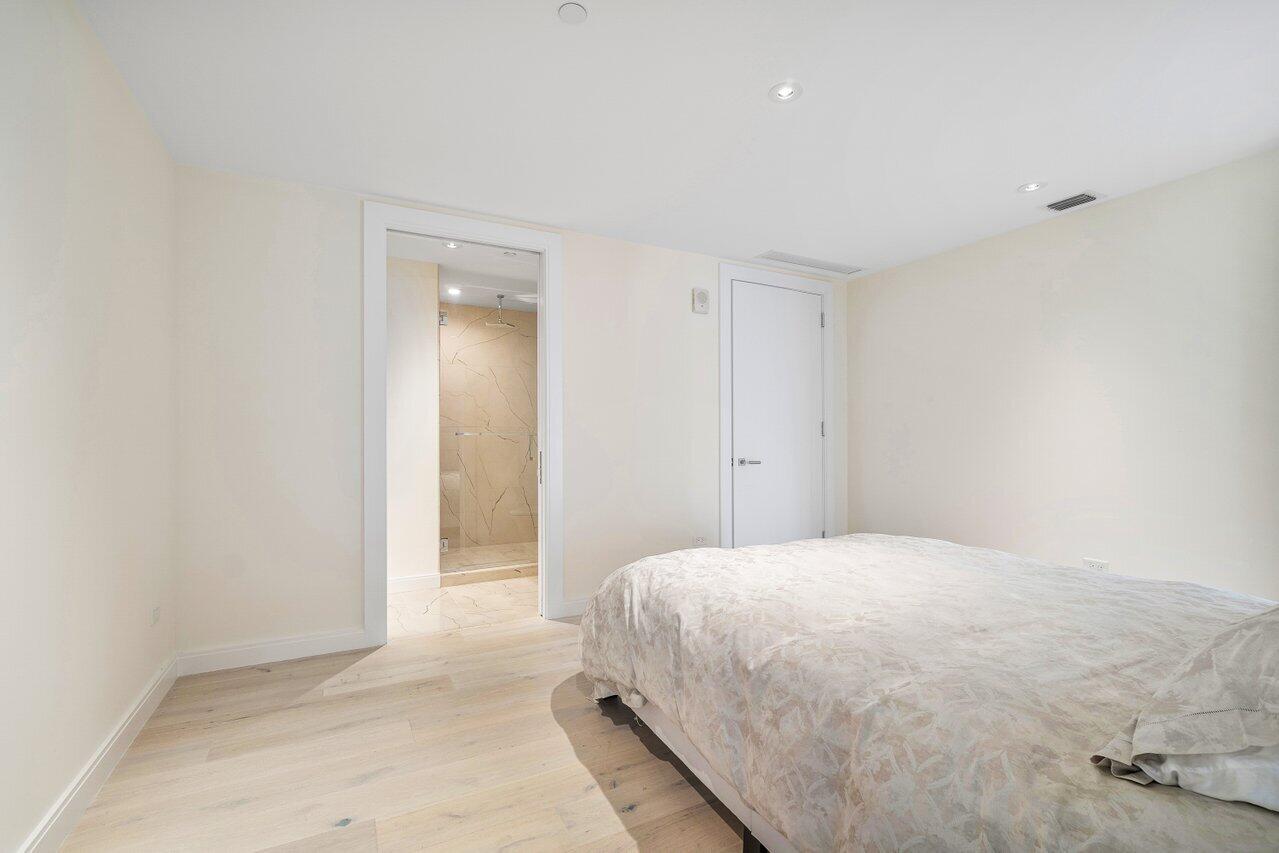 3550 South Ocean Boulevard, Unit 2D South Palm Beach, FL 33480 - Photo 24 of 55 a bedroom with a bed and a window