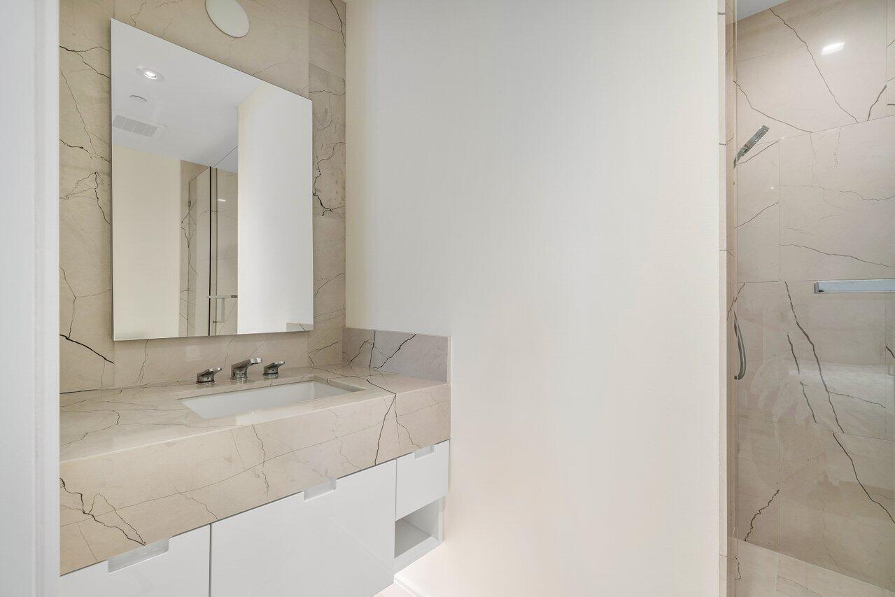 3550 South Ocean Boulevard, Unit 2D South Palm Beach, FL 33480 - Photo 25 of 55 a bathroom with a sink and a mirror