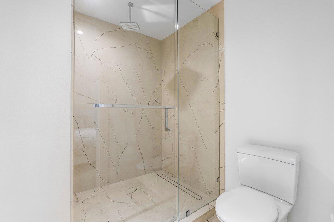 3550 South Ocean Boulevard, Unit 2D South Palm Beach, FL 33480 - Photo 26 of 55 a bathroom with a toilet and a shower