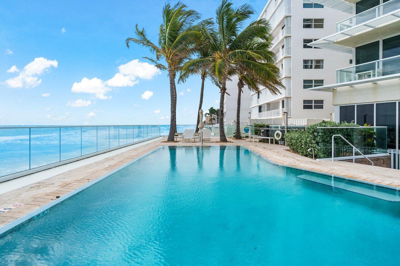 3550 South Ocean Boulevard, Unit 2D South Palm Beach, FL 33480 - Photo 35 of 55 a swimming pool with outdoor seating and yard