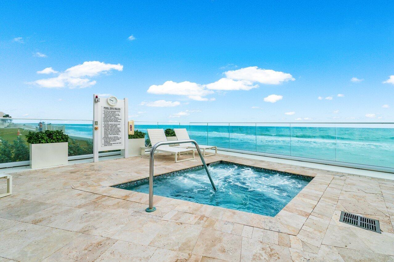 3550 South Ocean Boulevard, Unit 2D South Palm Beach, FL 33480 - Photo 39 of 55 a swimming pool with a yard and outdoor seating