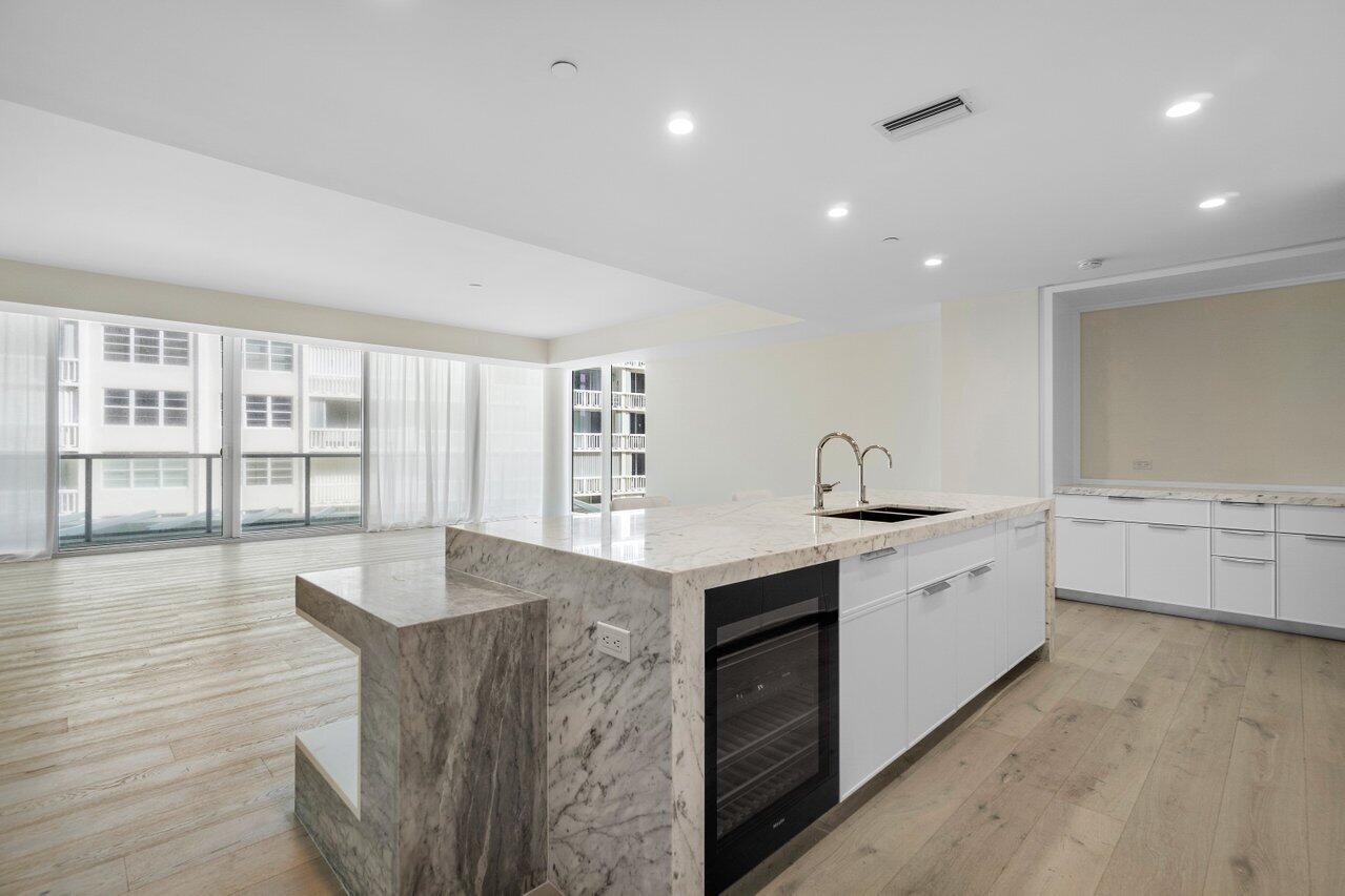 3550 South Ocean Boulevard, Unit 2D South Palm Beach, FL 33480 - Photo 8 of 55 a large kitchen with granite countertop a stove and a sink