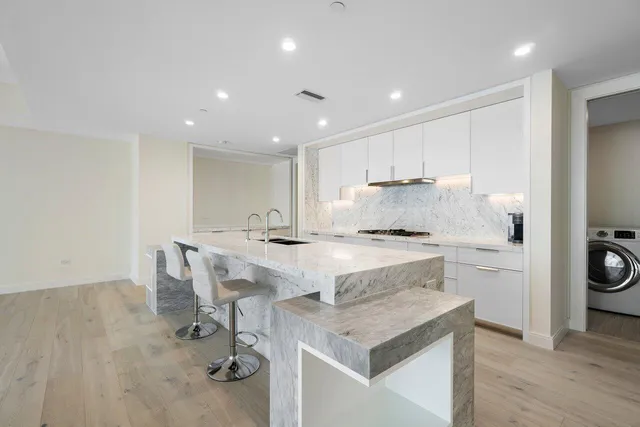 a kitchen with a stove a sink and a refrigerator