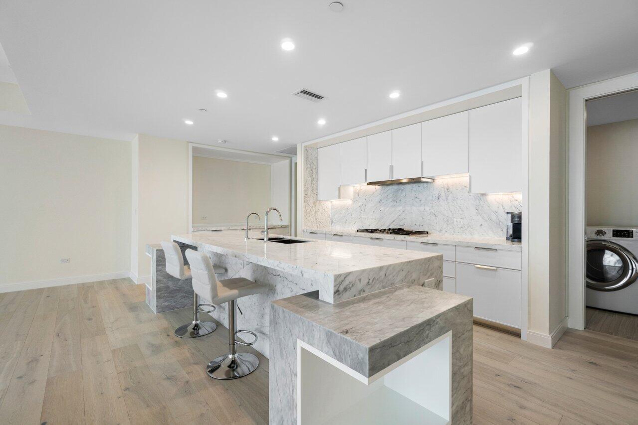 3550 South Ocean Boulevard, Unit 2D South Palm Beach, FL 33480 - Photo 9 of 55 a kitchen with a stove a sink and a refrigerator