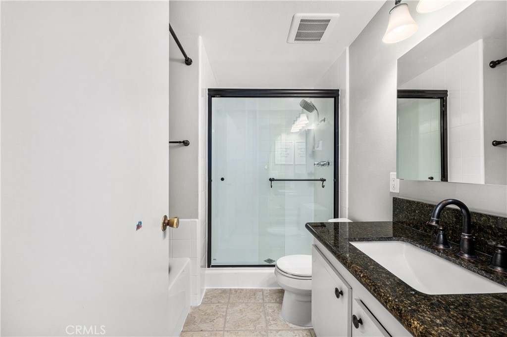 4237 Larwin Avenue Cypress, CA 90630 - Photo 26 of 48 a bathroom with a granite countertop sink toilet and shower