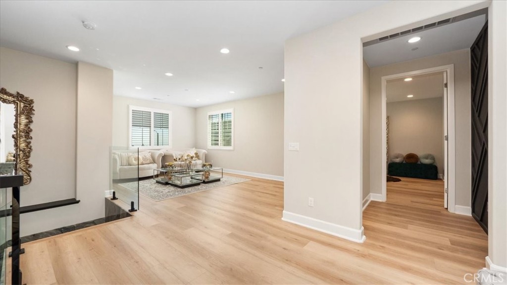 8798 JUSTIFY Drive Rancho Cucamonga, CA 91701 - Photo 11 of 26 a room with furniture and a wooden floor