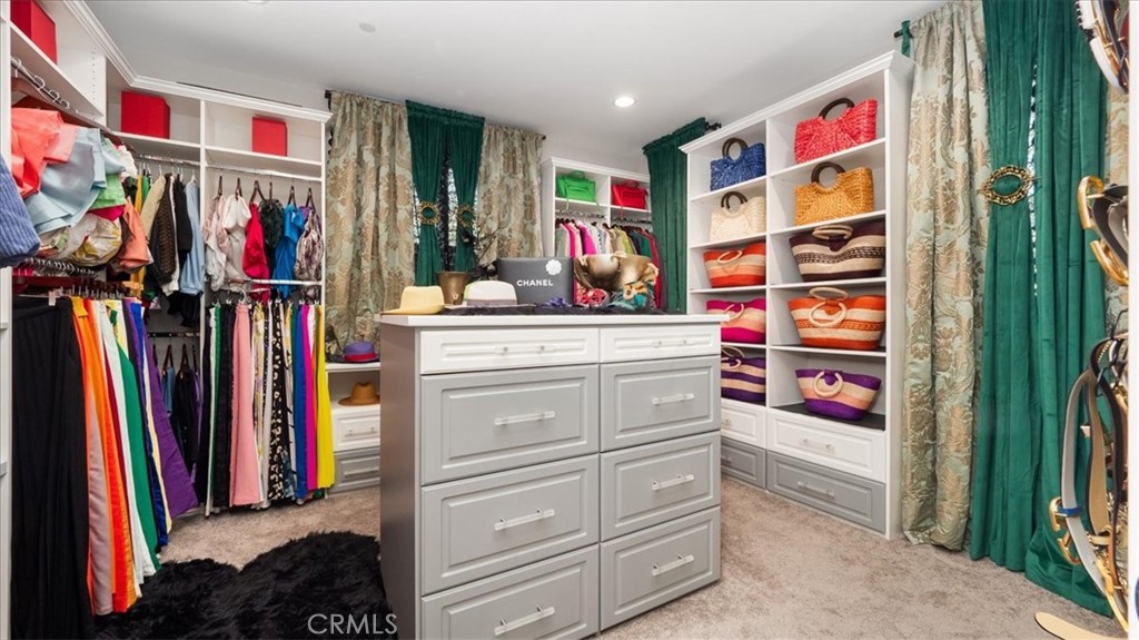 8798 JUSTIFY Drive Rancho Cucamonga, CA 91701 - Photo 14 of 26 a view of walk in closet with clothes and shoes