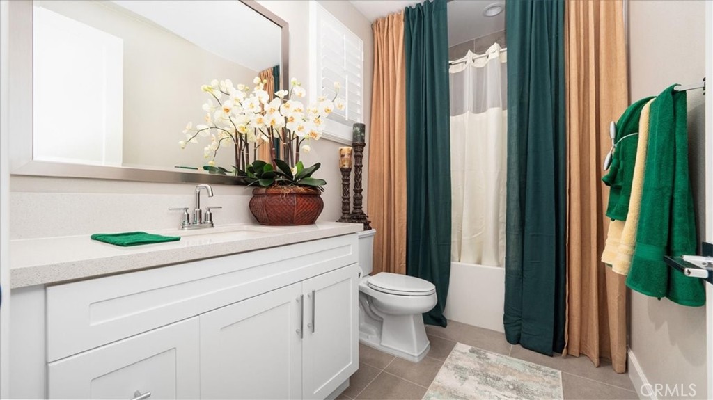 8798 JUSTIFY Drive Rancho Cucamonga, CA 91701 - Photo 19 of 26 a bathroom with a sink a mirror and a potted plant