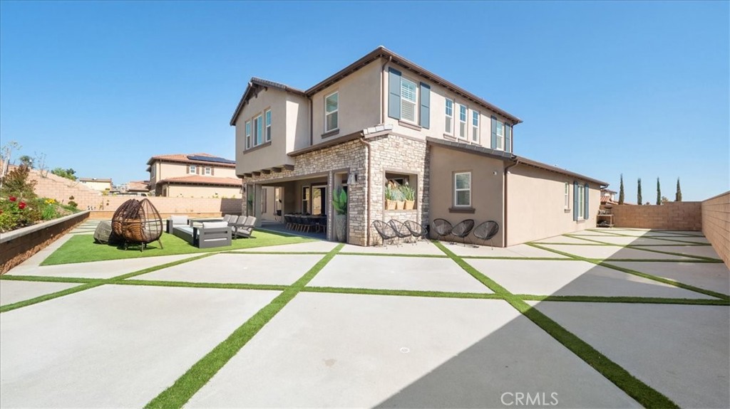 8798 JUSTIFY Drive Rancho Cucamonga, CA 91701 - Photo 20 of 26 a front view of a house with a basket ball court and a fire pit
