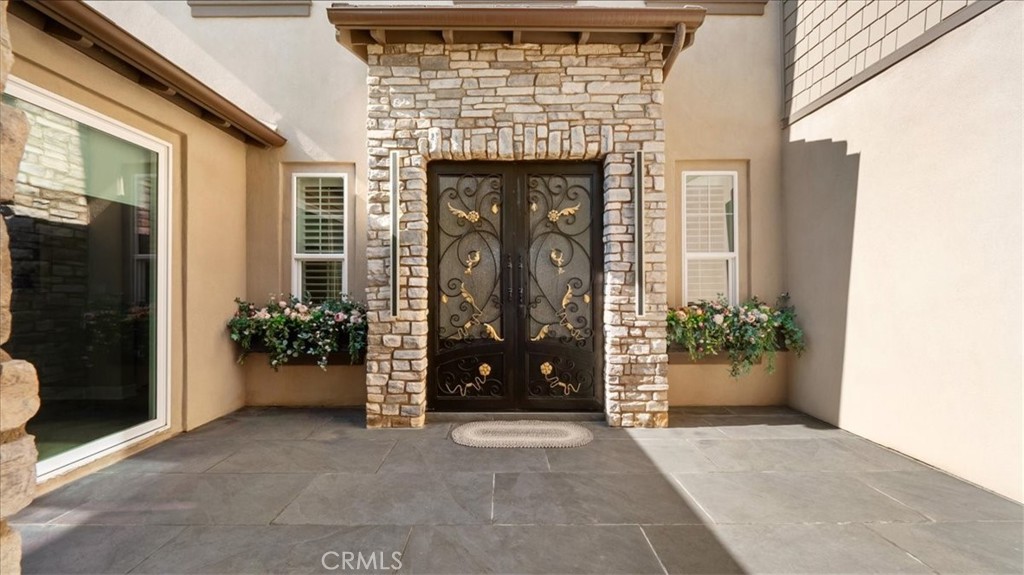 8798 JUSTIFY Drive Rancho Cucamonga, CA 91701 - Photo 2 of 26 a front view of a house with garden