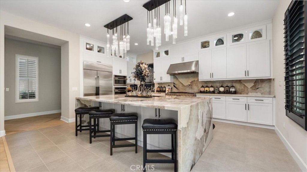 8798 JUSTIFY Drive Rancho Cucamonga, CA 91701 - Photo 6 of 26 a kitchen with cabinets and chairs