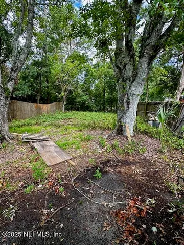 a view of a backyard with large trees
