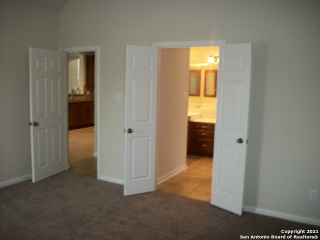 16202 Juan Tabo Way Helotes, TX 78023 - Photo 11 of 22 an empty room with windows and a bathroom
